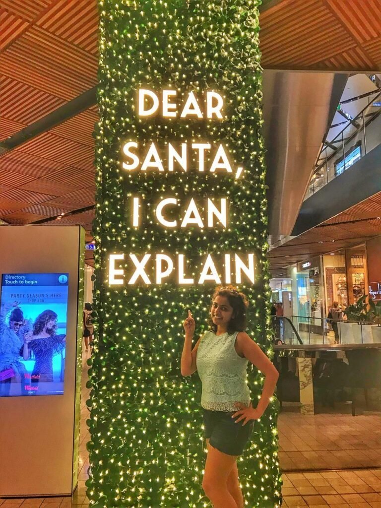 A girl standing in front of a signage